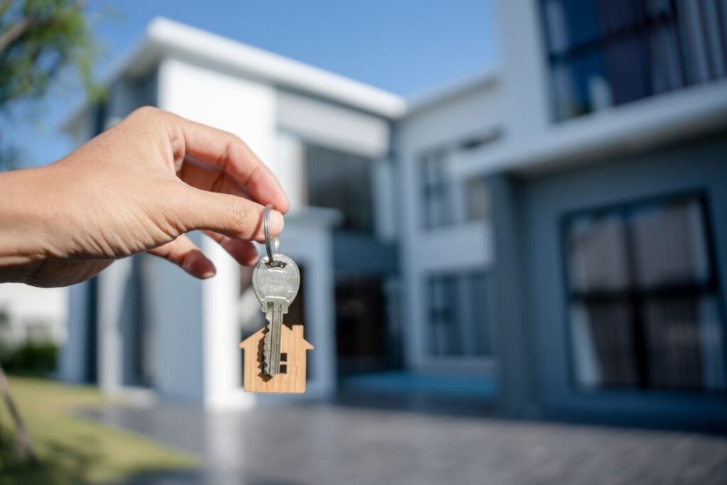 Buy house in Dubai key handover in front of modern home symbolizing successful property purchase