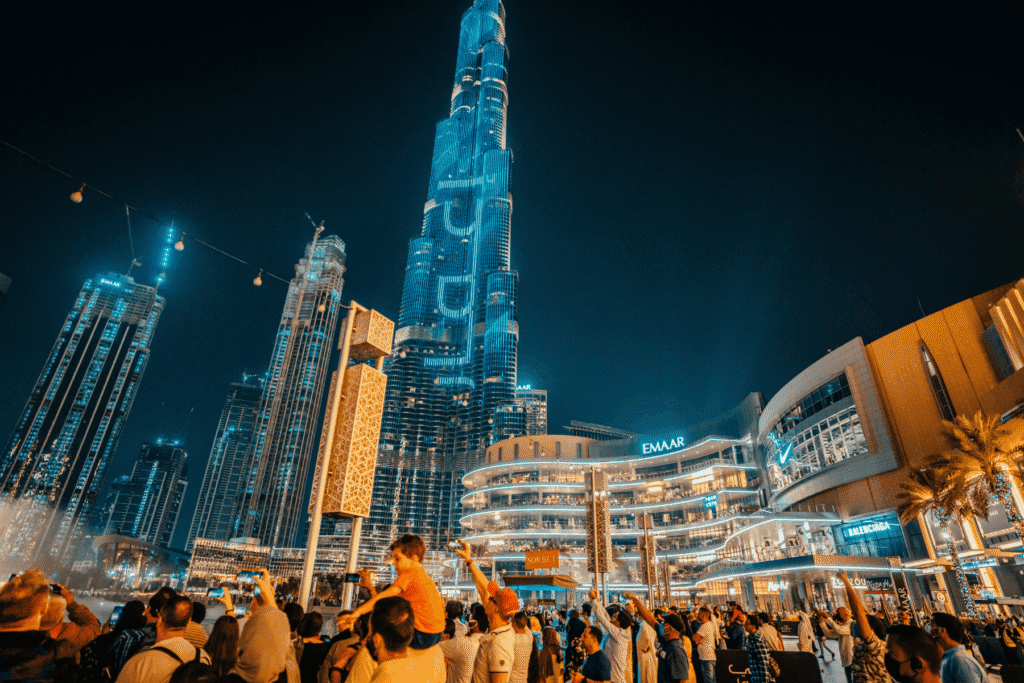 Belebter Platz am Burj Khalifa bei Nacht als Symbol für Dubai Sicherheit und öffentliches Leben in der Stadt
