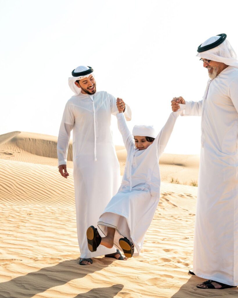 Familie in traditioneller Kleidung in der Wüste Dubais