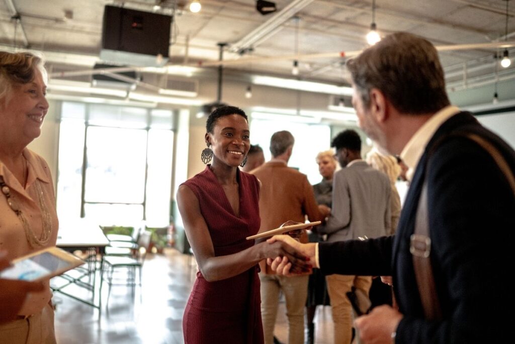Work in Dubai networking event with handshake between business professionals