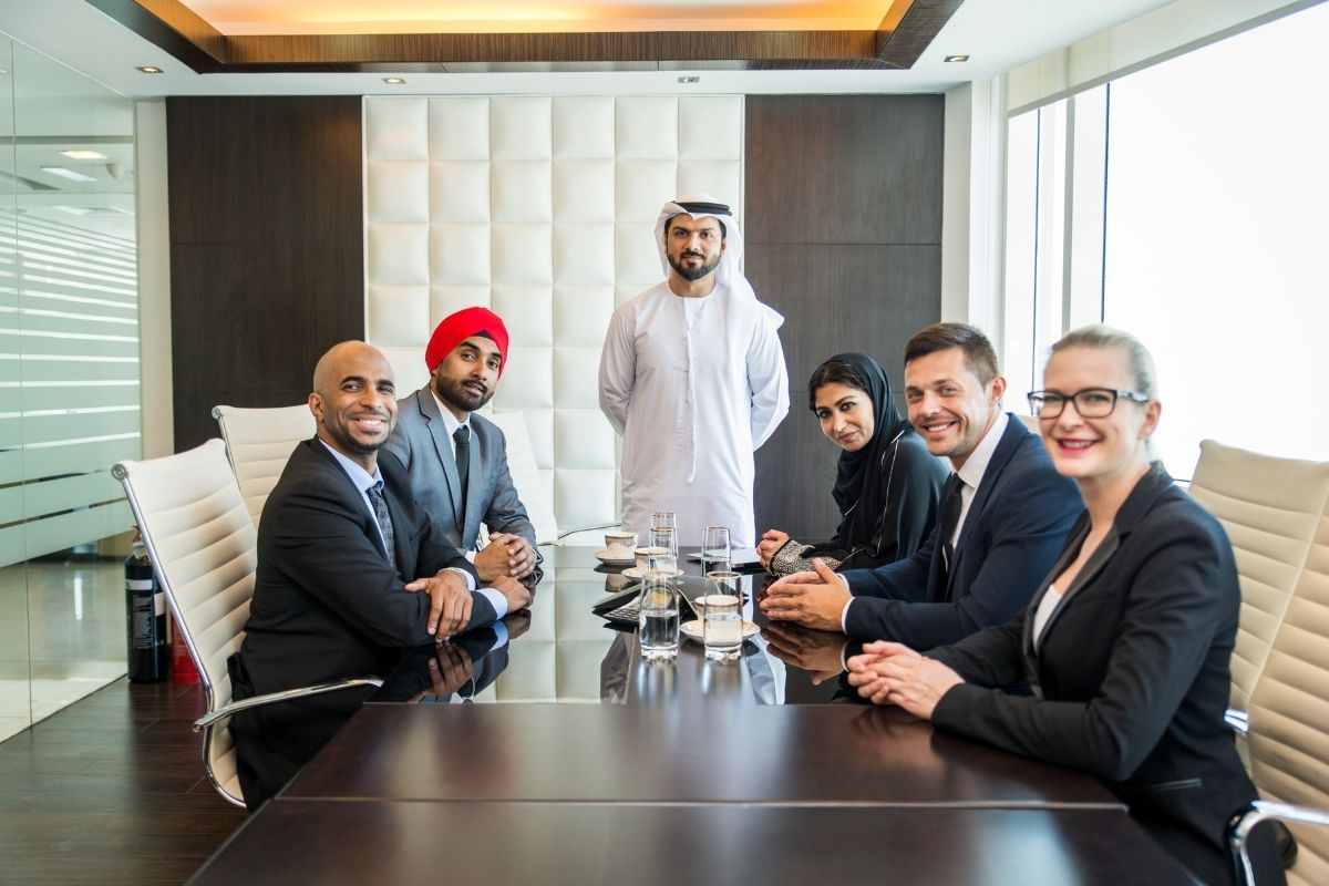 Taxes in Dubai business meeting – international team discussing financial