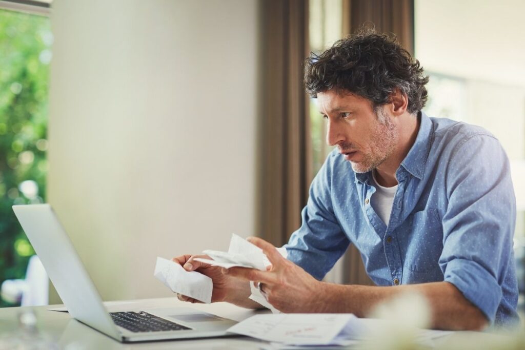 Man reviewing expenses and cost planning for living in Dubai on a laptop