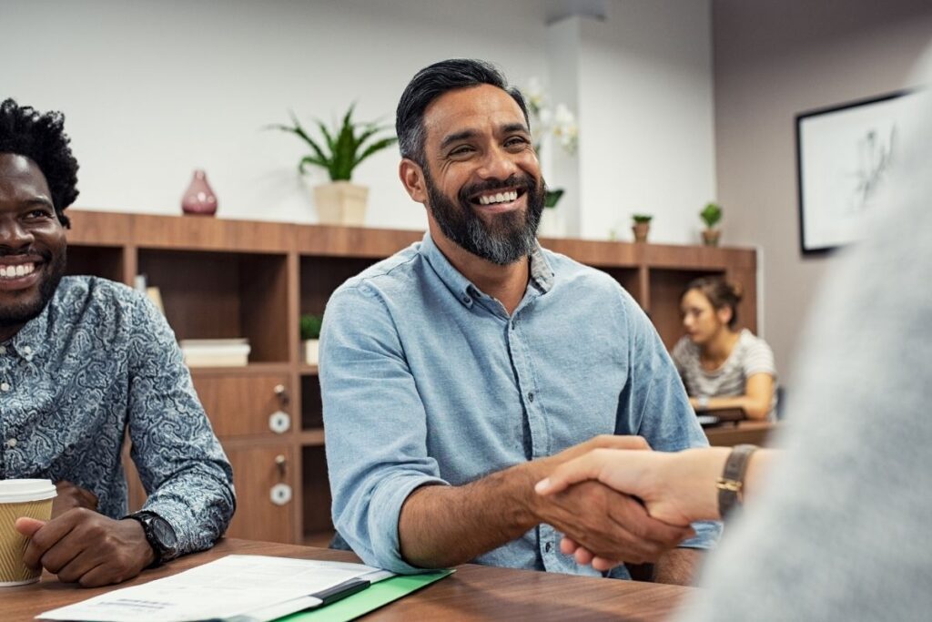 Company formation Dubai starts with a successful business deal and handshake between entrepreneurs