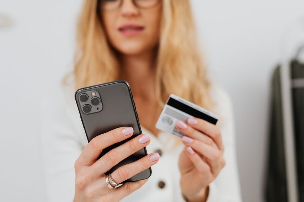 Taxes in Dubai finance – woman making online payment with smartphone and credit card