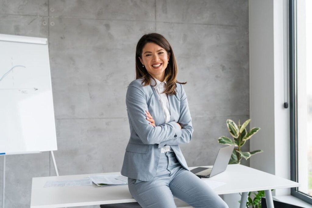 Businesswoman standing in office environment representing skilled professionals qualifying for Dubai Golden Visa
