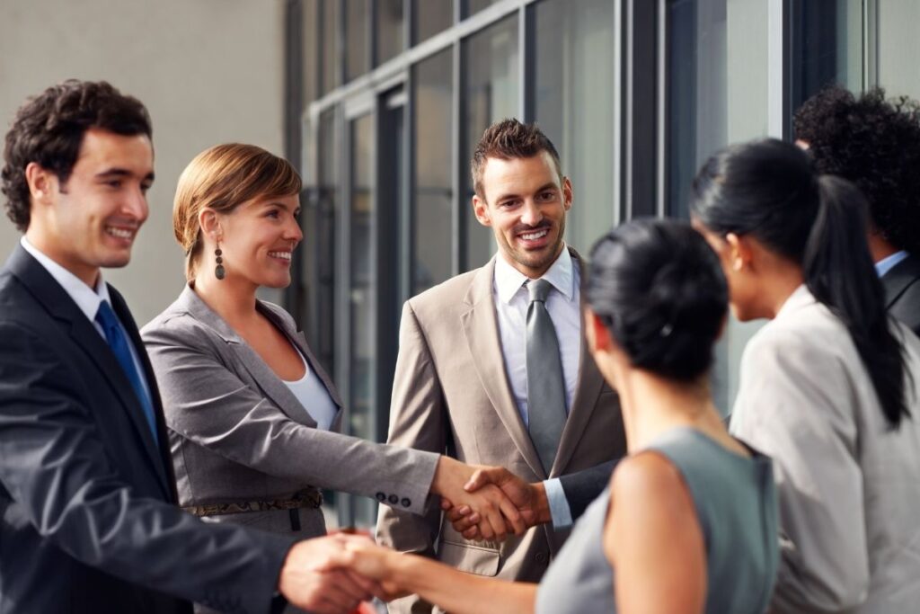 Business professionals shaking hands in a meeting symbolizing investment and business opportunities Dubai Golden Visa