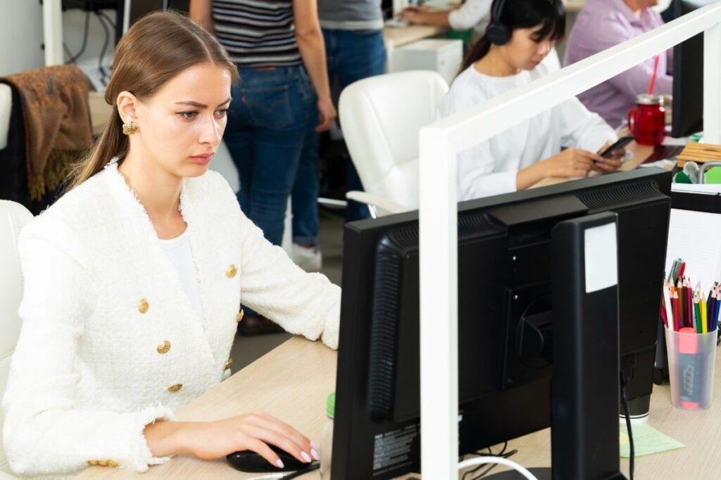 Woman working on laptop in office related to Dubai visa and employment