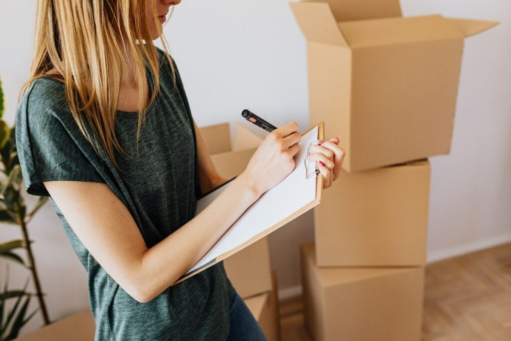 Woman writing a moving checklist for relocating to Dubai